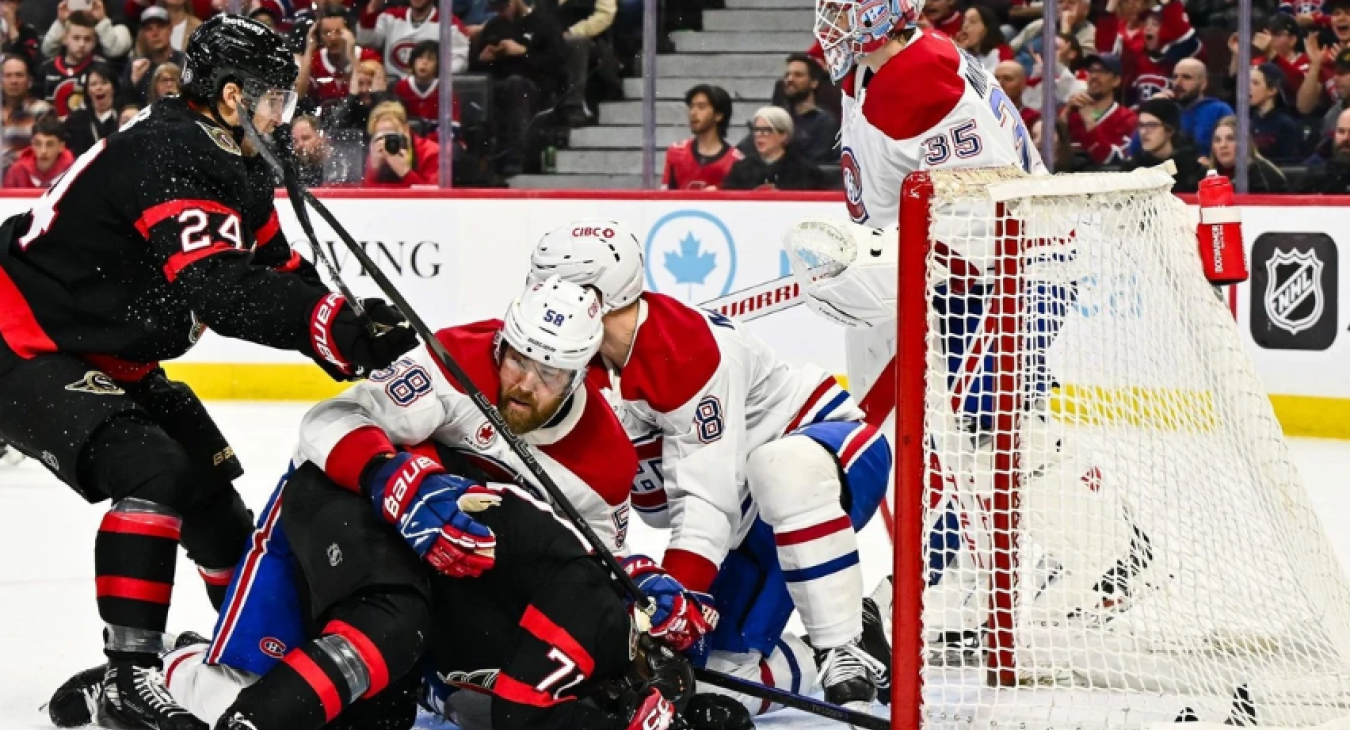 David Savard #58 of the Montreal Canadiens holds down Ridly Greig #71 of the Ottawa Senators
